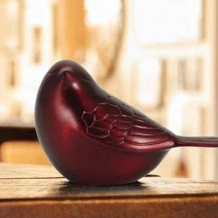 brass songbird on table