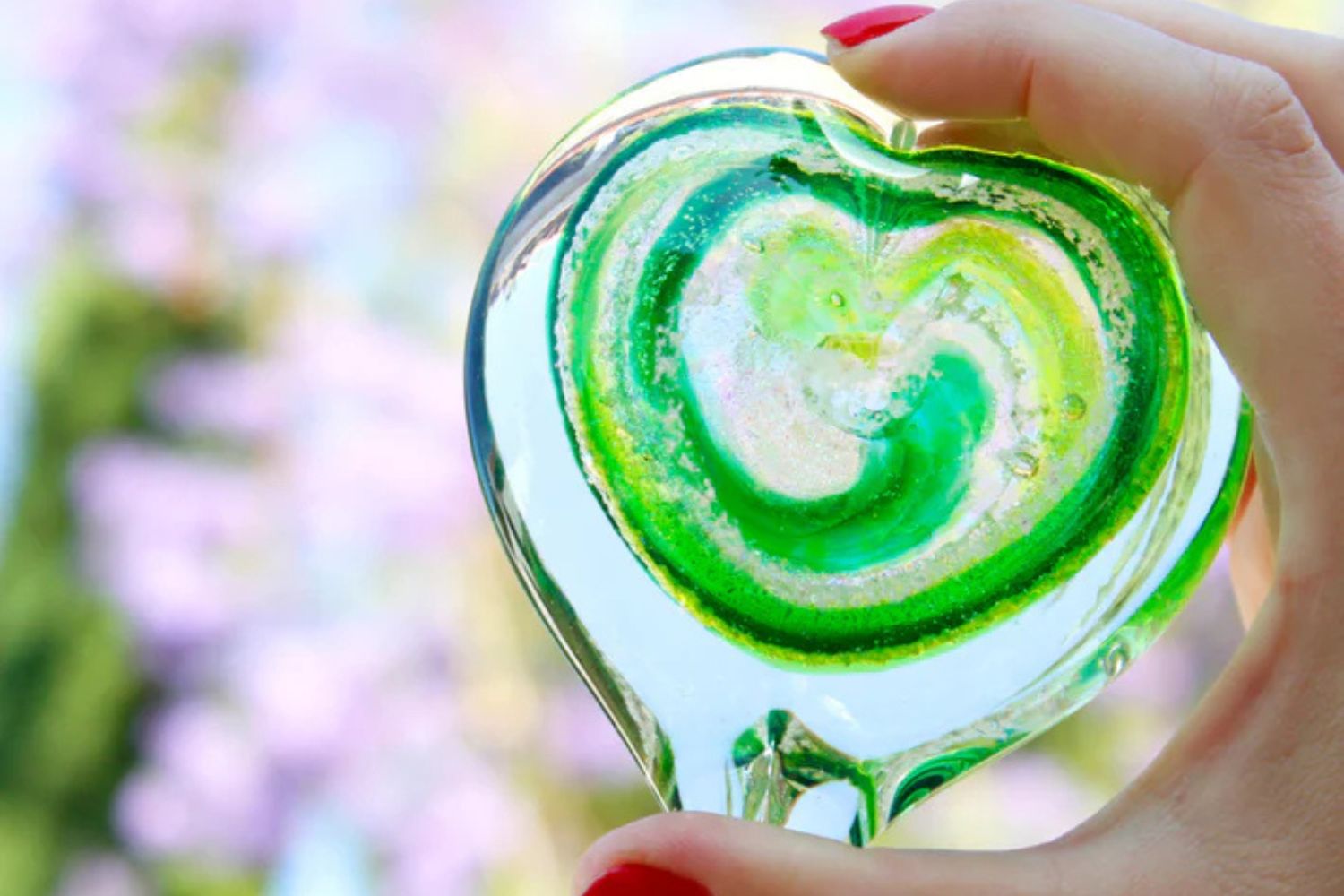woman holding green glass memorial stone