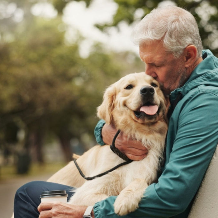 man holding his dog in a chair