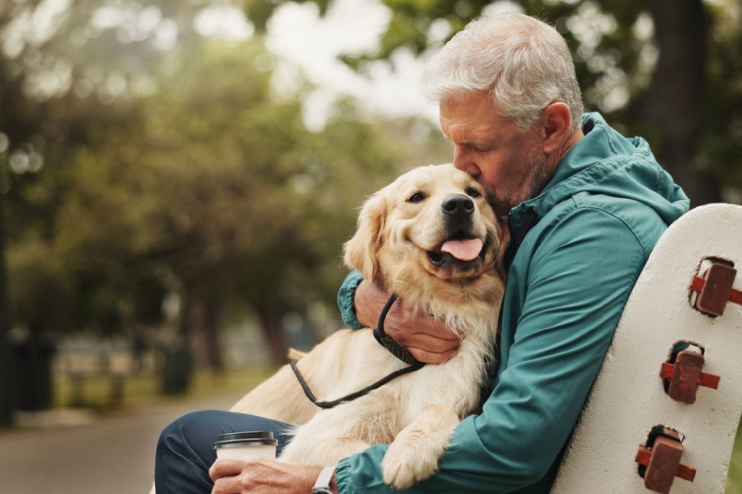 man holding his dog in a chair