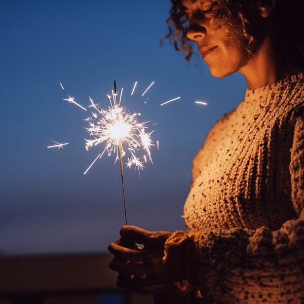 a person grieving holding a sparkler 