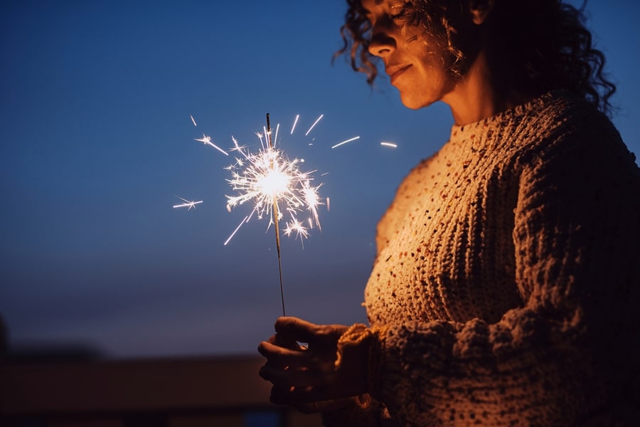 a person grieving holding a sparkler 