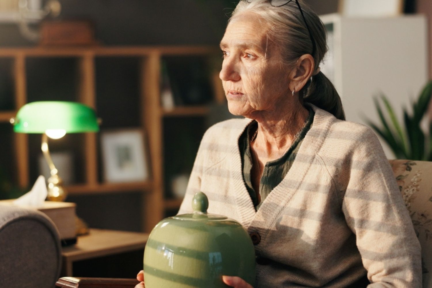 elderly woman holding an urn